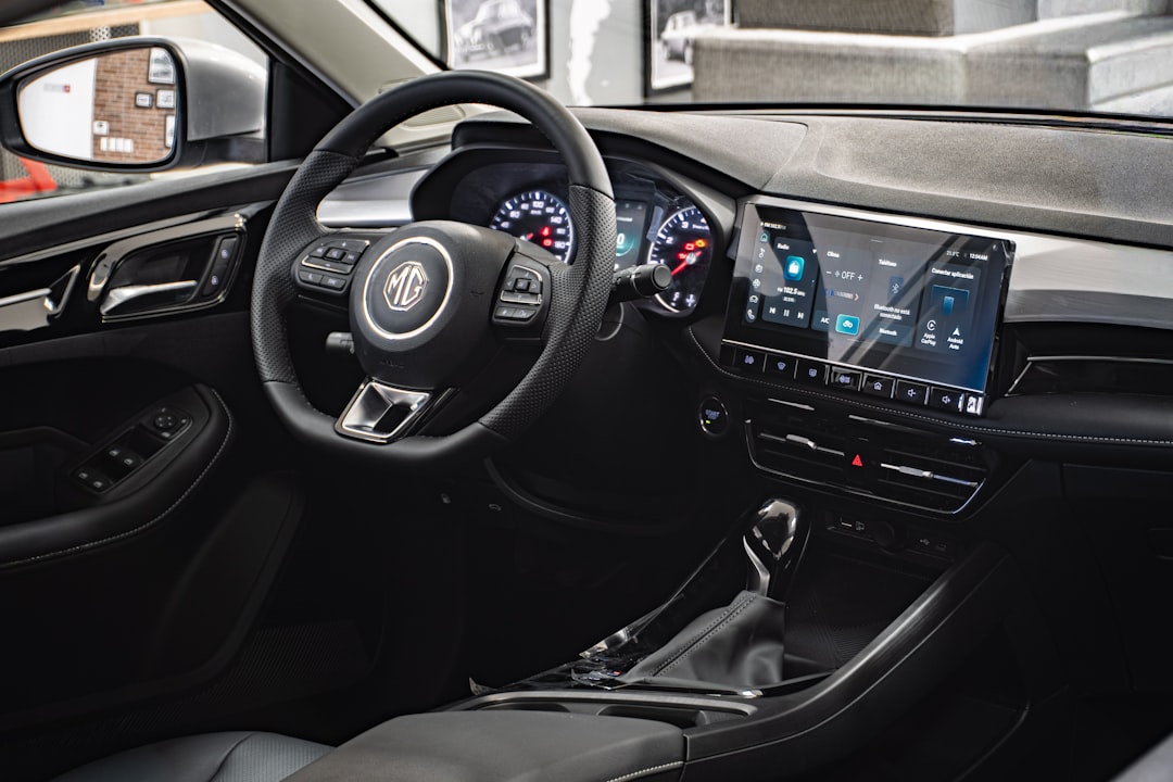 Interior of a modern car featuring a digital dashboard, touchscreen display, multifunction steering wheel, and automatic gear shift lever. Interior of a modern car featuring a digital dashboard, touchscreen display, multifunction steering wheel, and automatic gear shift lever.